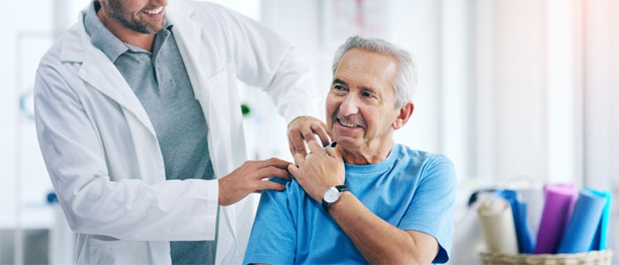 photo of a doctor with his hand on patients shoulder